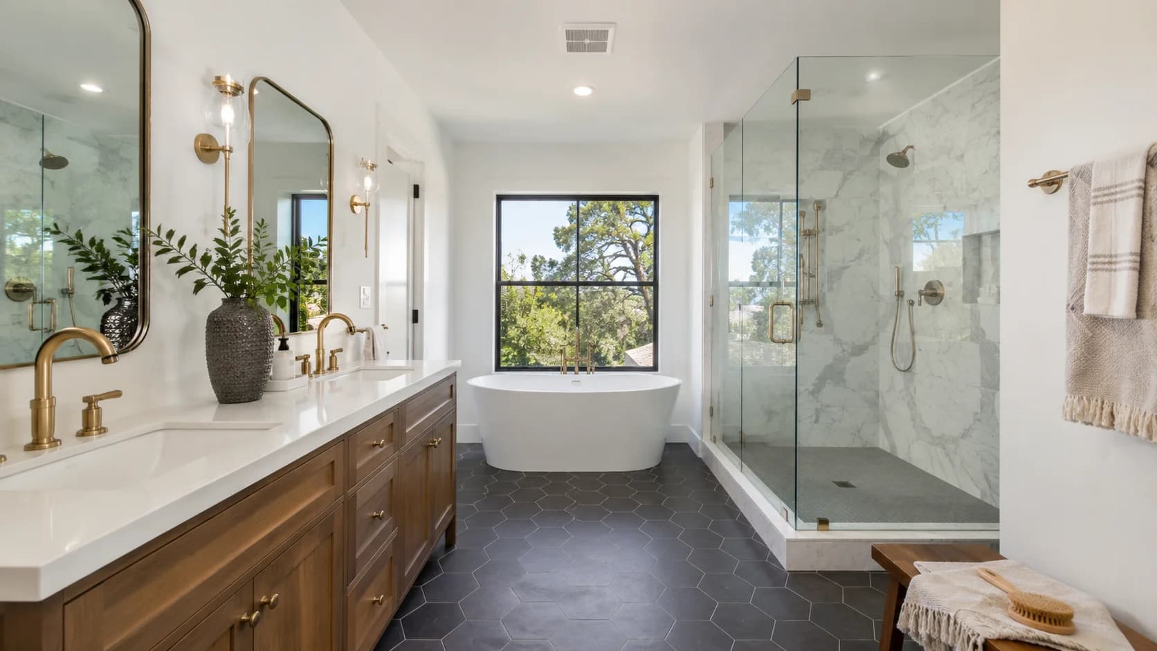 Primary bathroom with a freestanding tub, glass-enclosed marble shower and hexagon tile floor